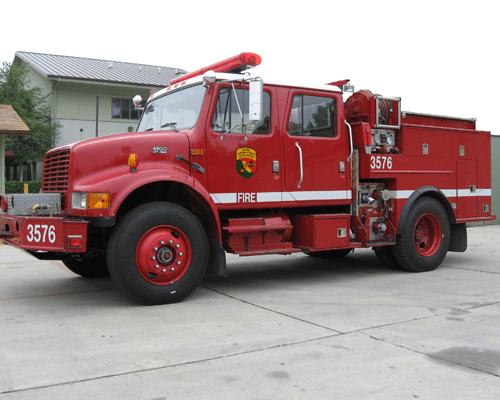 Red colored fire engine with four doors