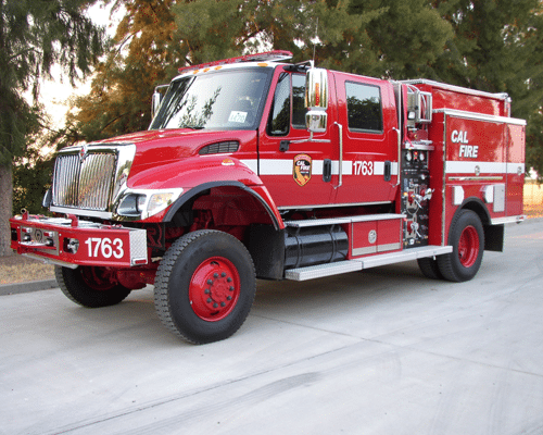 The front side of a red colored fire engine