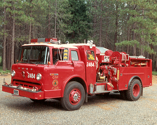 Red colored vintage fire engine in the woods